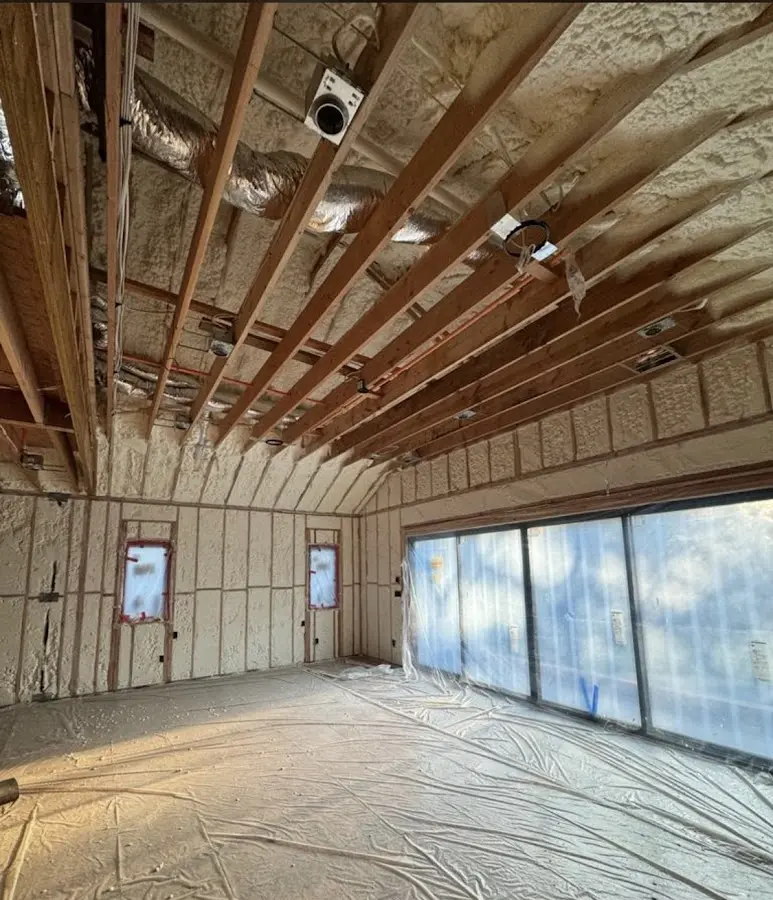 Interior walls and ceiling insulated with spray foam during new construction in Corcoran